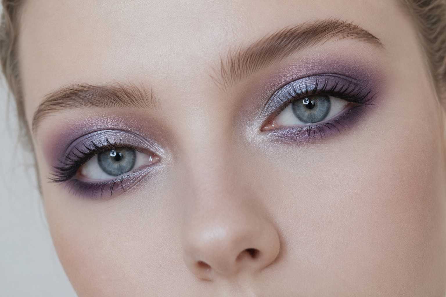 Woman with cool undertone skin wearing cool-toned purple and rose eyeshadow, demonstrating how cool colors harmonize with fair, cool-toned complexion