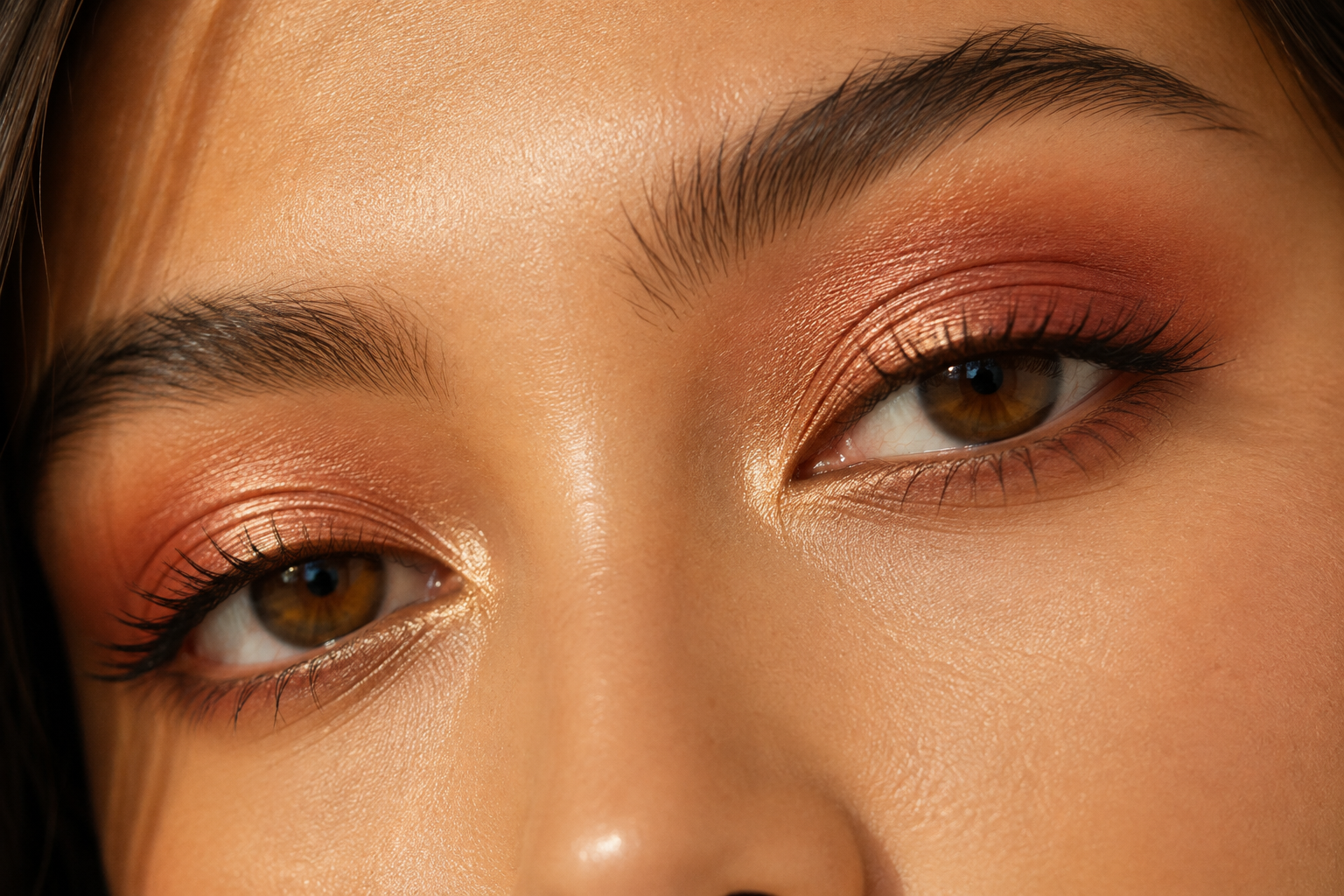Woman with warm golden undertone skin wearing warm-toned orange and bronze eyeshadow, showing how warm eyeshadow colors enhance warm complexion